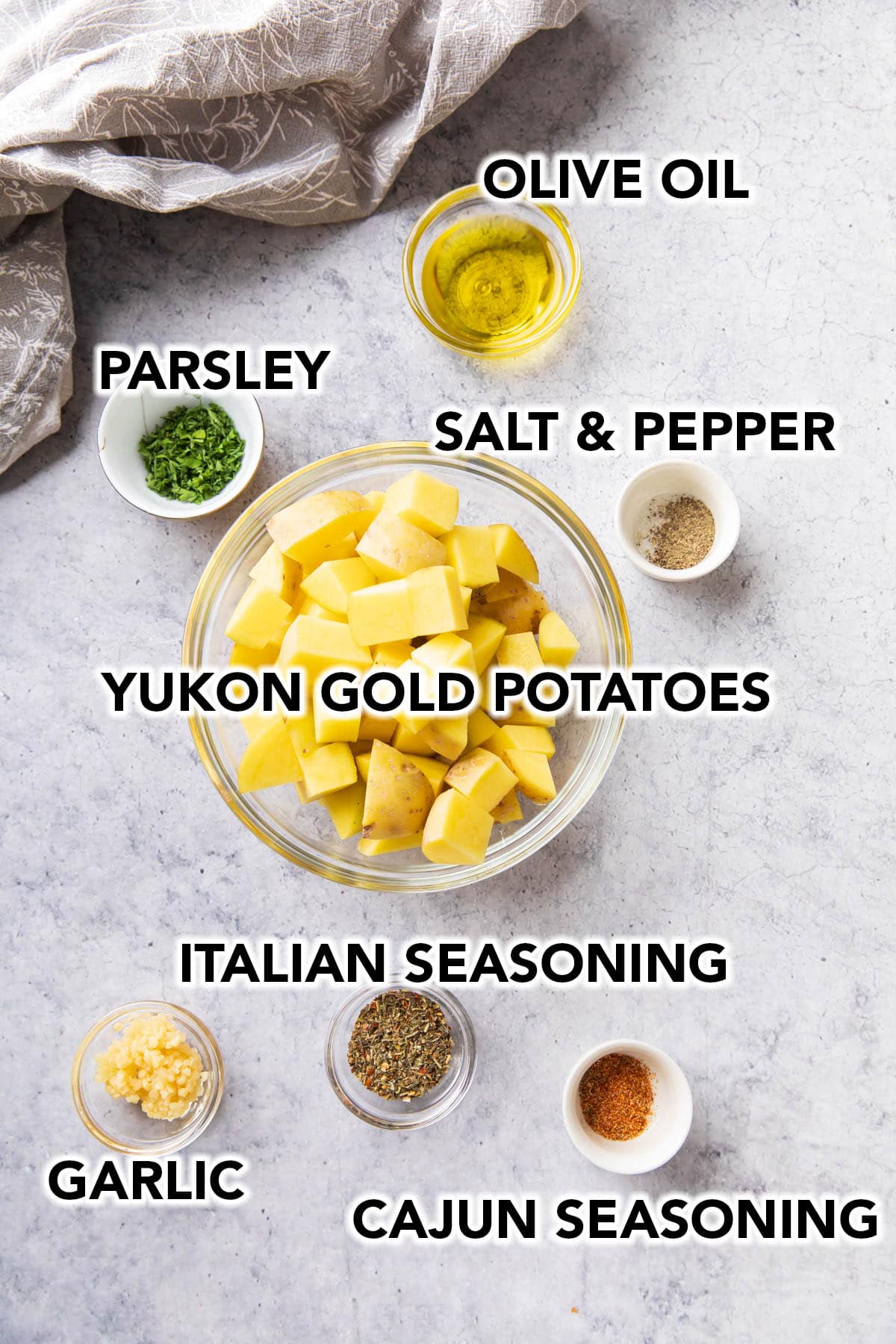 Ingredients for Air Fryer Roasted Potatoes including Yukon gold potatoes, seasonings, and olive oil.