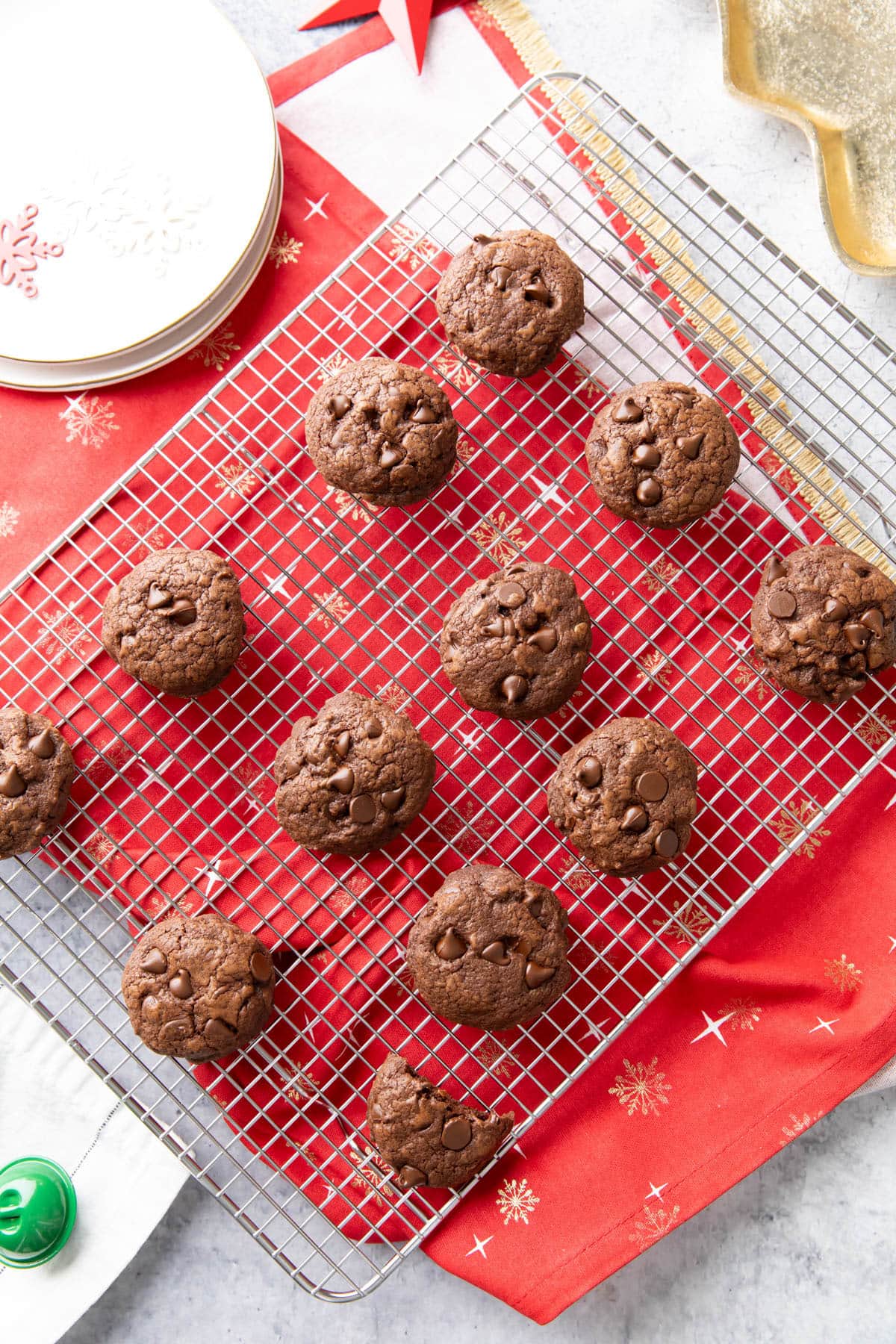 A kitchen table with plates, a rack of these baked goods, a serving tray, and decor