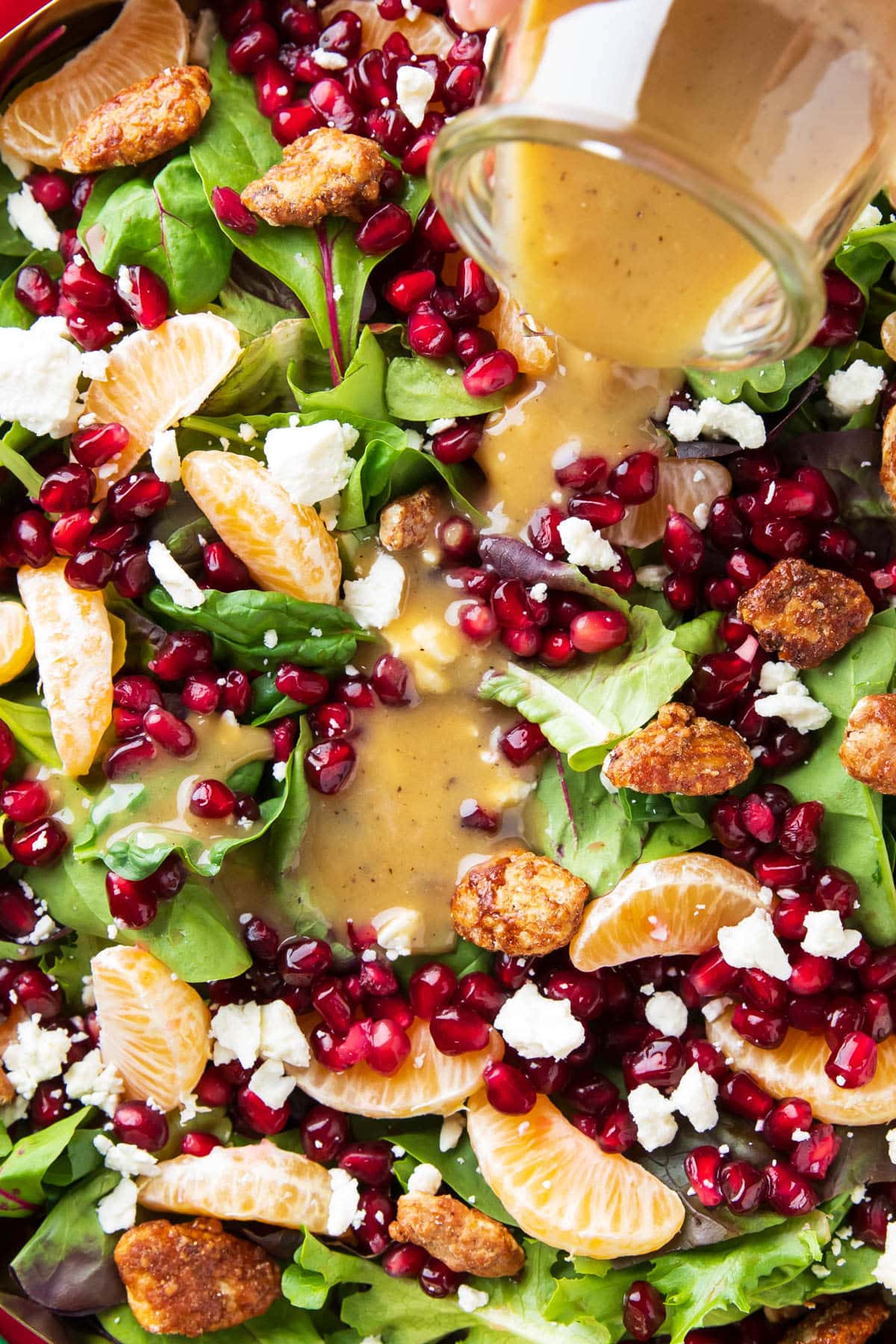 Pouring the best honey mustard dressing recipe over a salad.