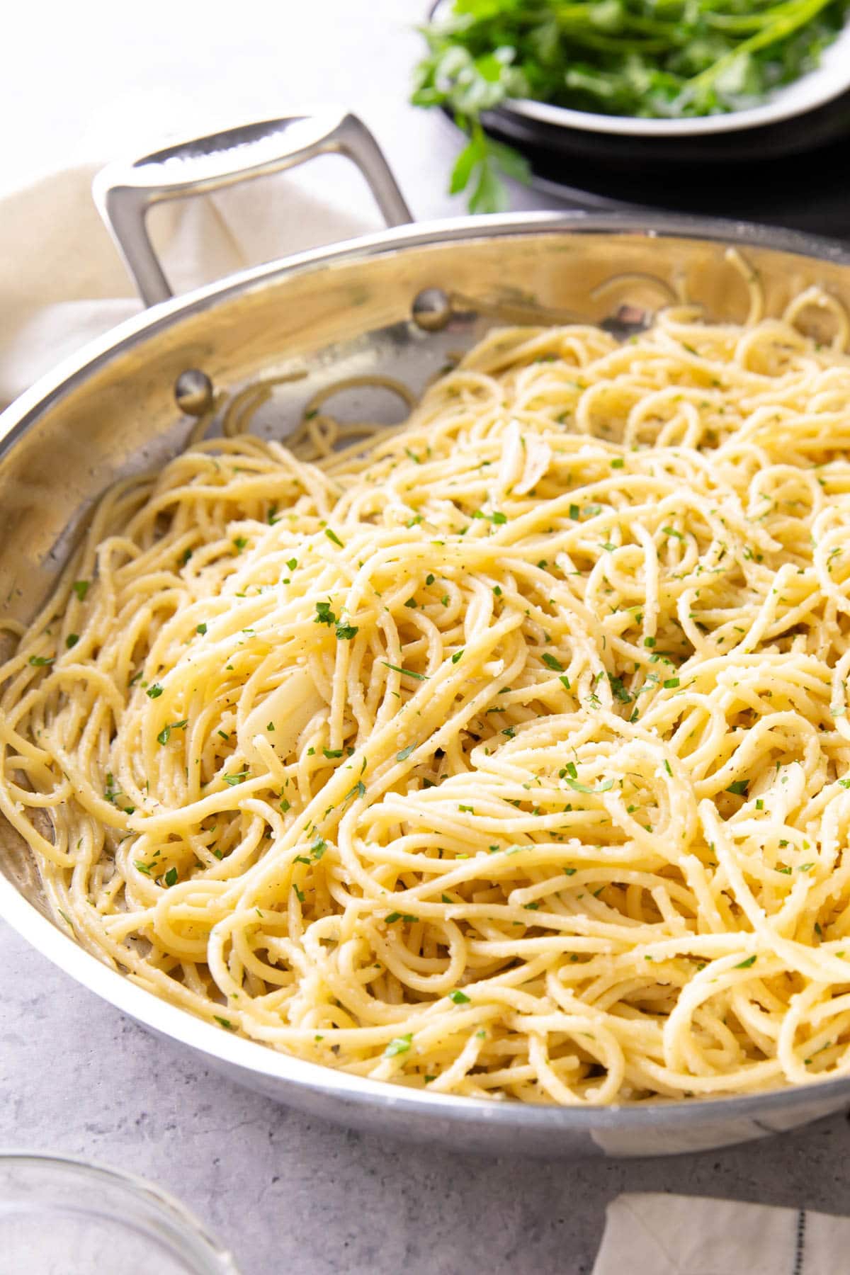Garlic Butter Pasta in a skillet topped with parmesan and fresh chopped parsley and coated with Garlic Butter Pasta Sauce