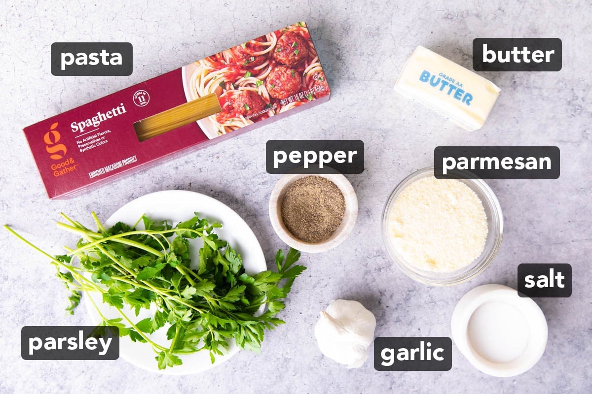 Garlic Butter Pasta ingredients measured and prepped for cooking, including spaghetti, butter, parsley, salt, pepper, and garlic.