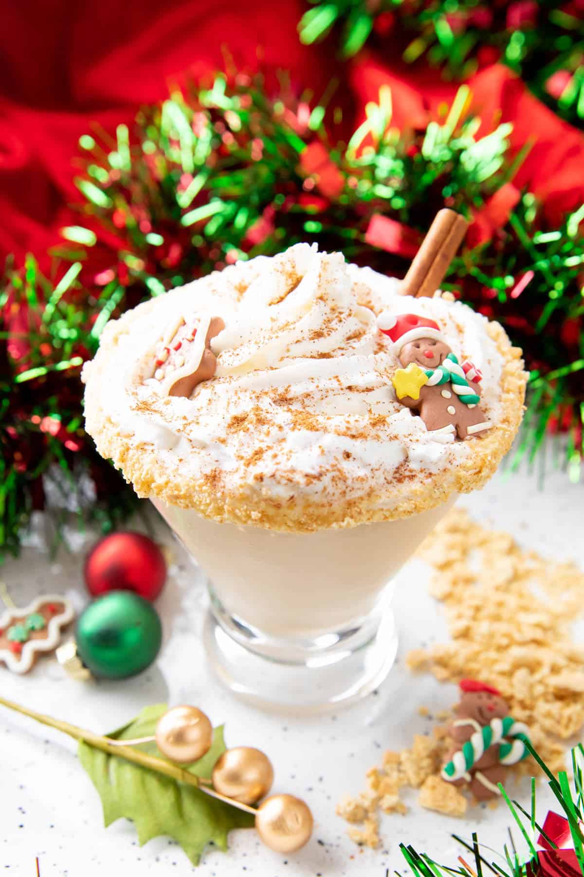 Closeup photo of gingerbread martini topped with whipped cream and a gingerbread cookie
