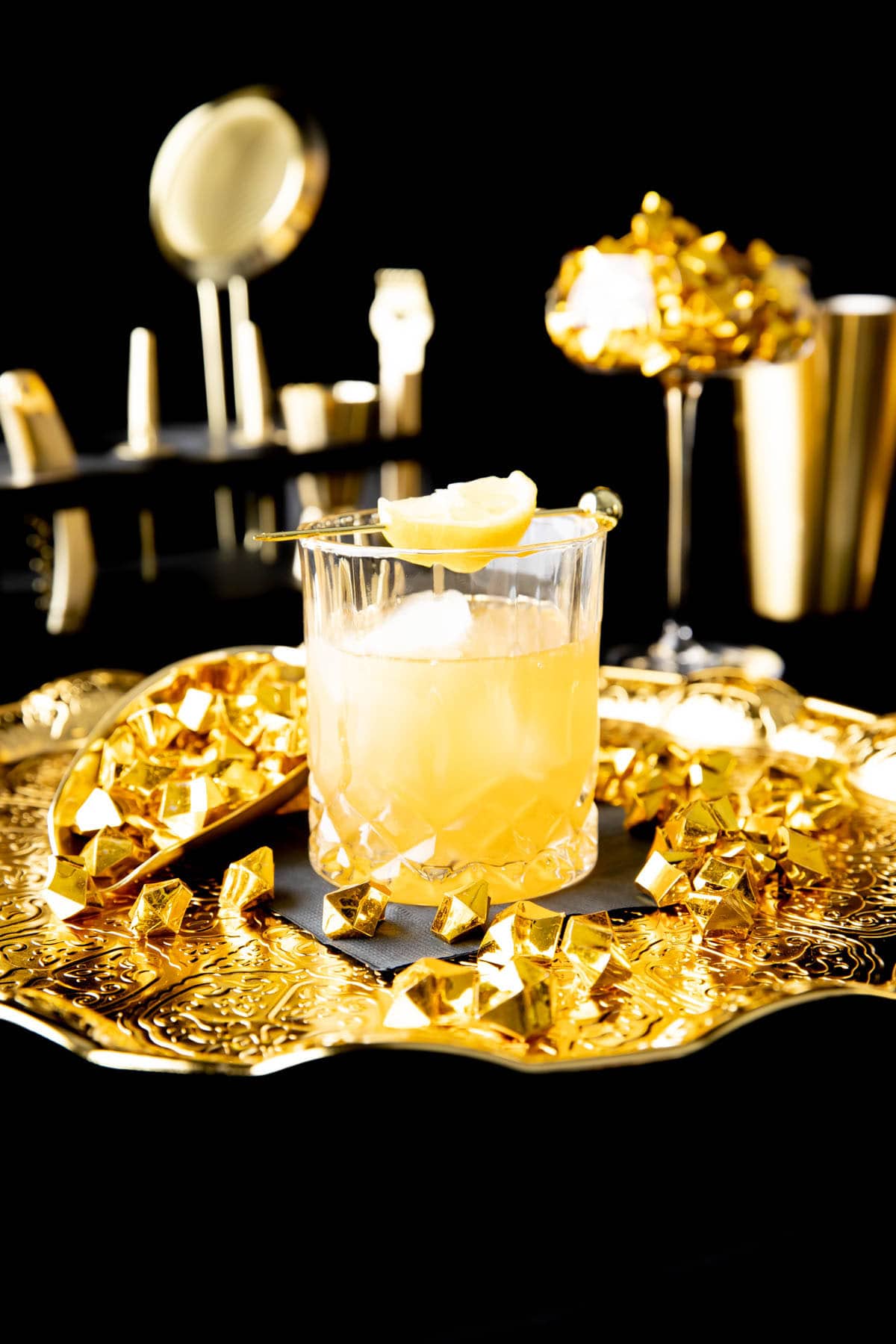 this drinks recipe served on platter with a napkin and bartending accessories