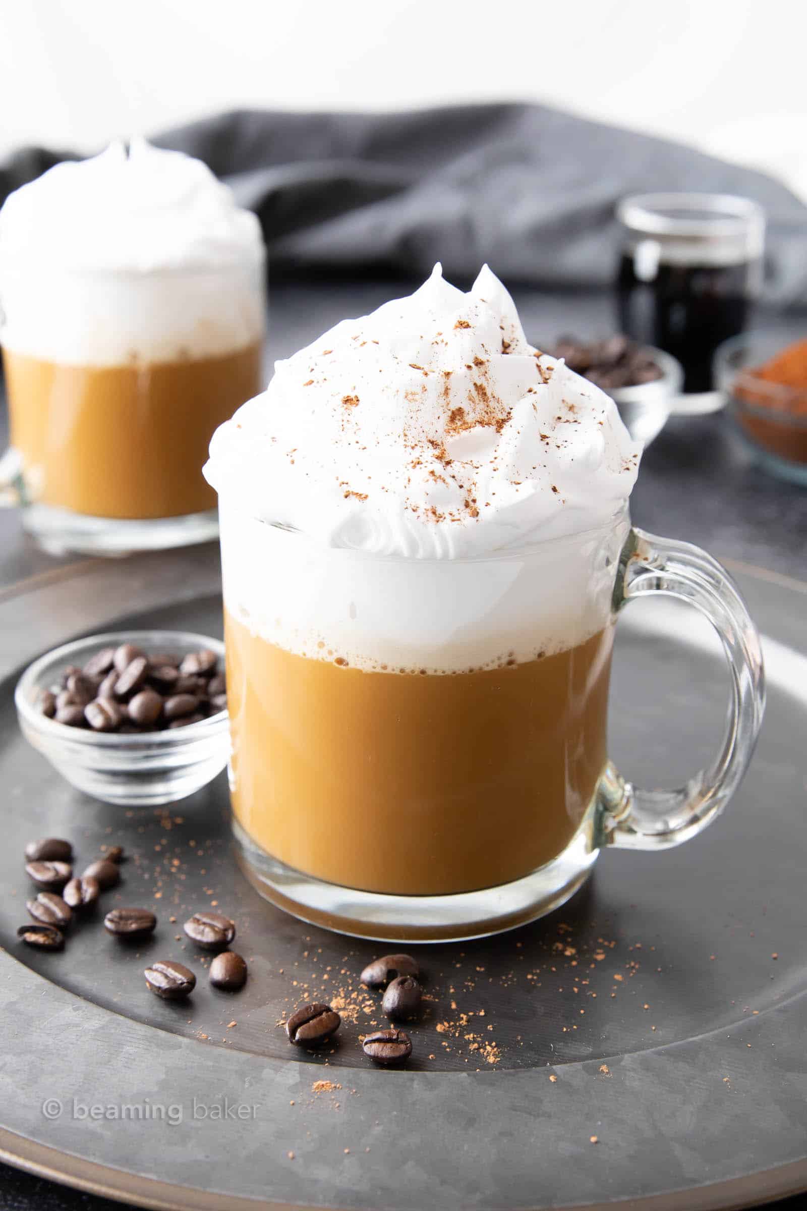 piping hot white russian in a glass with coffee beans.
