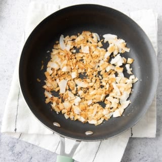 Cooling Toasted Coconut in Pan on a kitchen towel