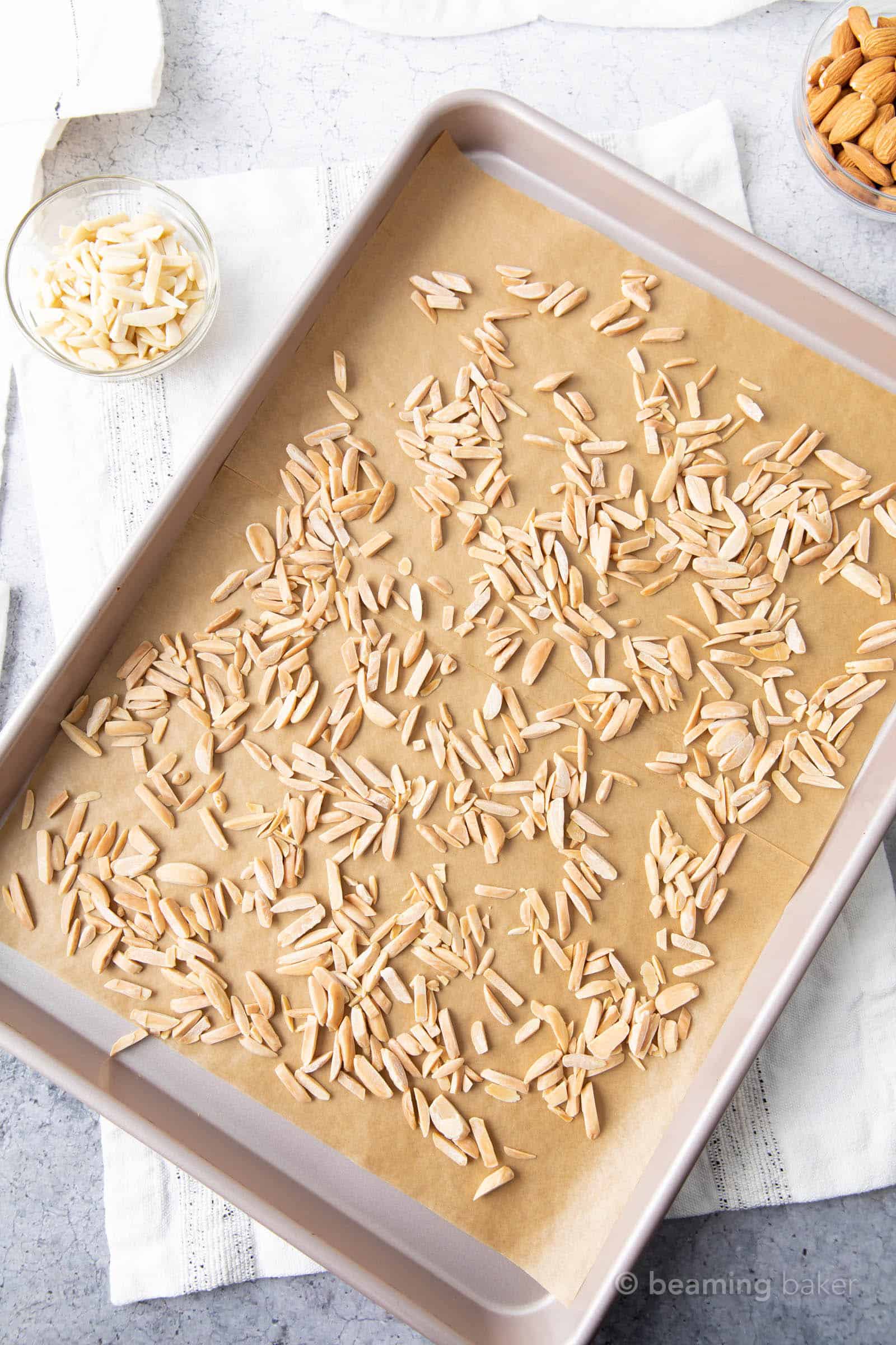 toasted slivered almonds on parchment paper