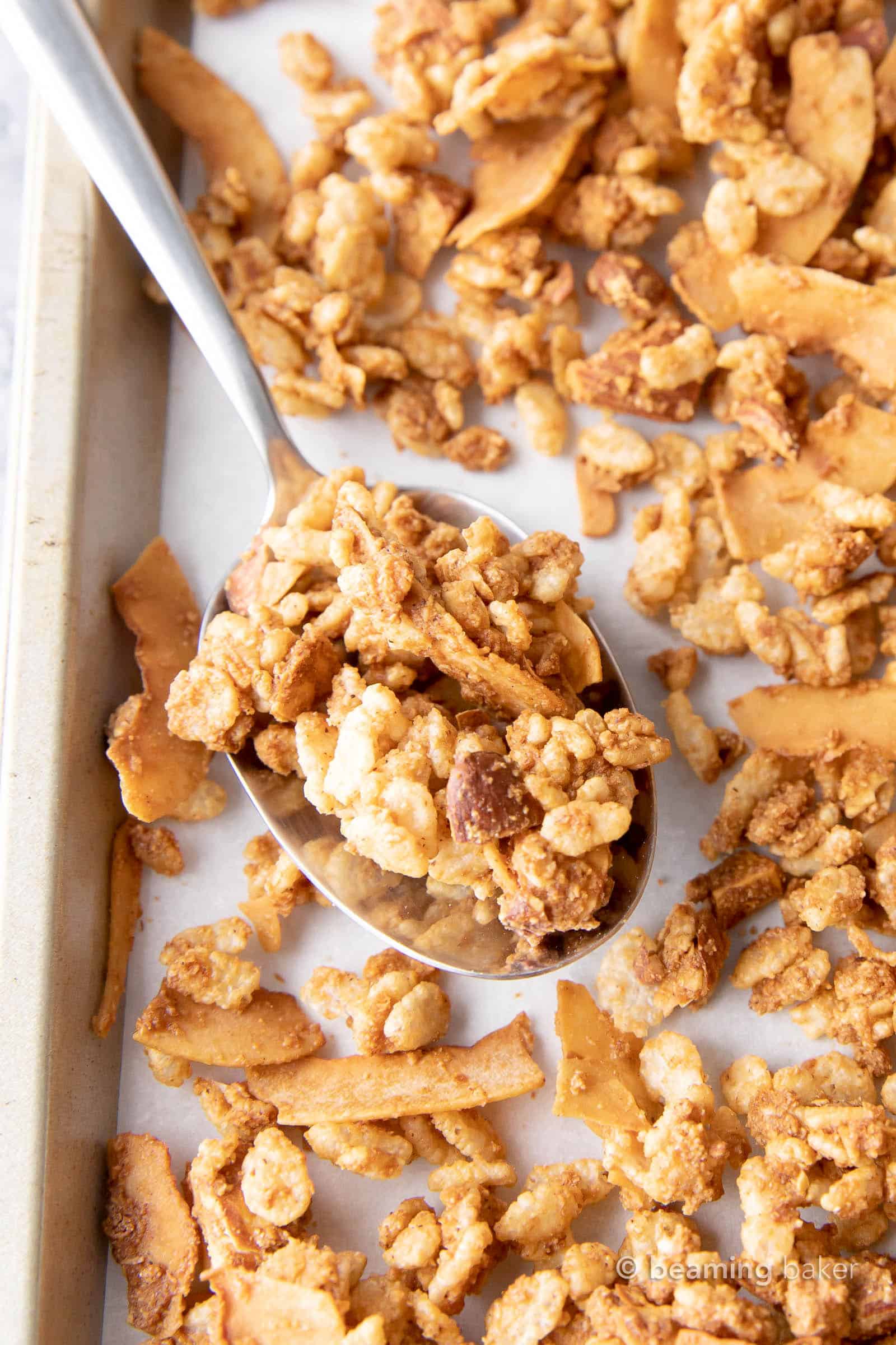 Close up of a spoon full of low calorie granola to show crunchy clusters.