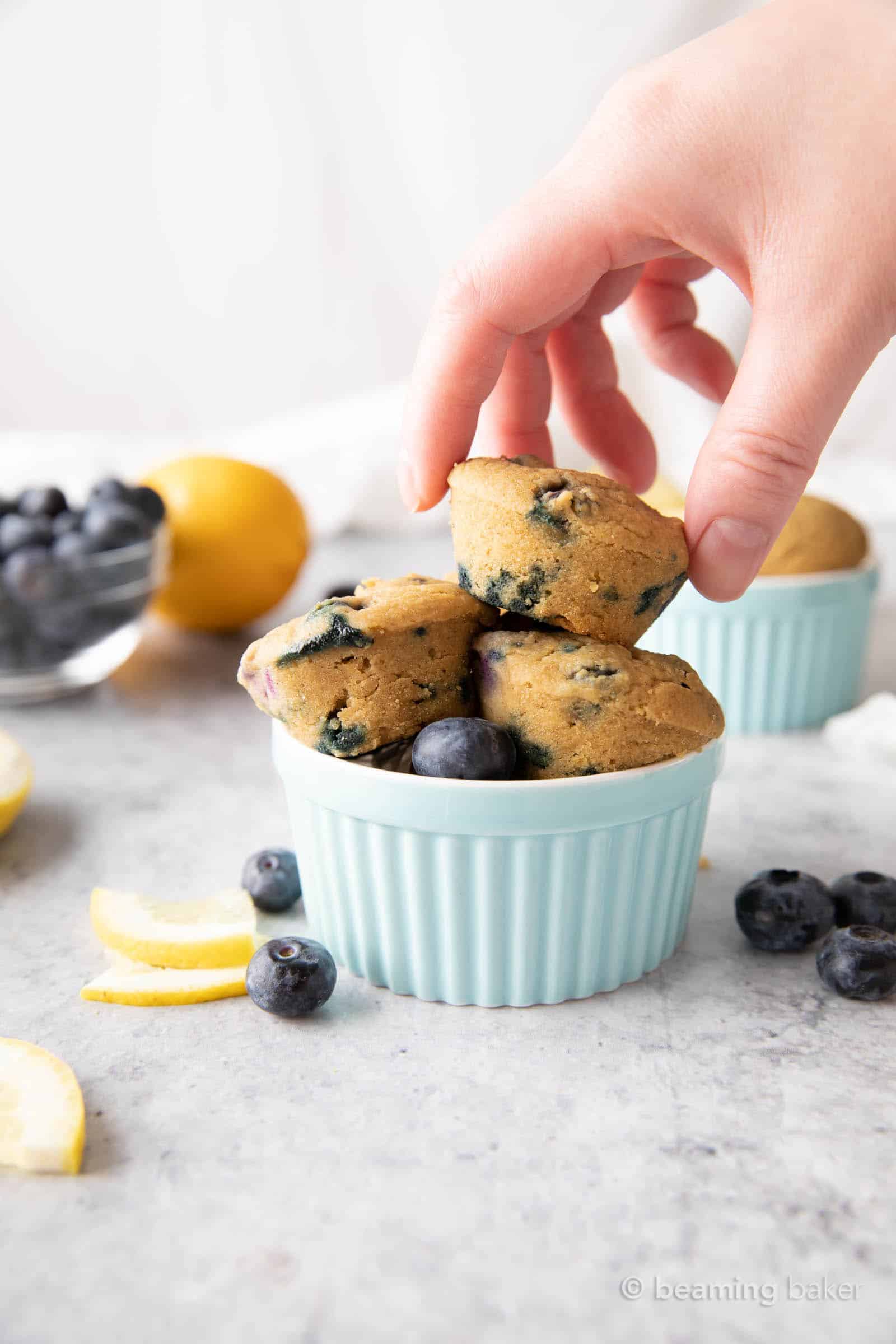 Mini Vegan Lemon Blueberry Muffins: super cute, mini-sized moist vegan lemon blueberry muffins. Bright blueberry & fresh lemon flavor packed into tiny vegan muffins! #Vegan #Lemon #Blueberry #Muffins | Recipe at BeamingBaker.com