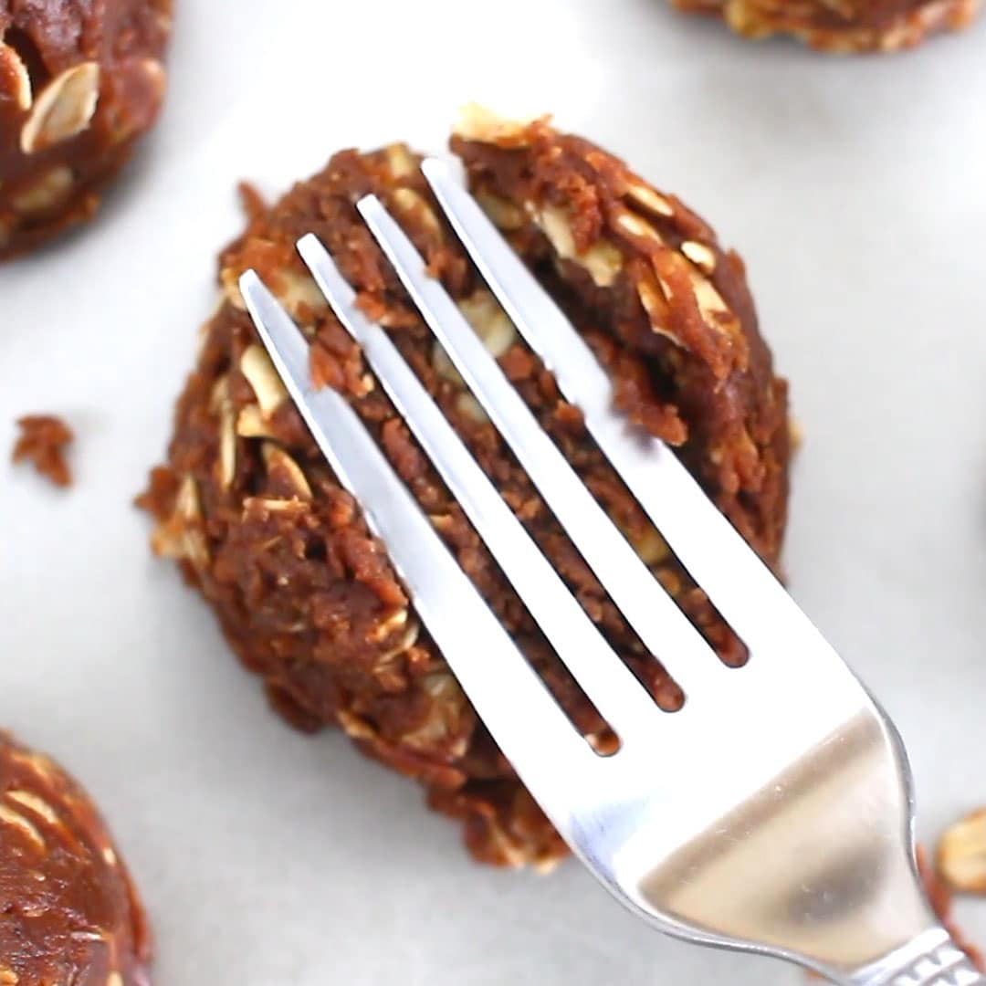 Using a fork to flatten no bake cookie dough into a cookie shape