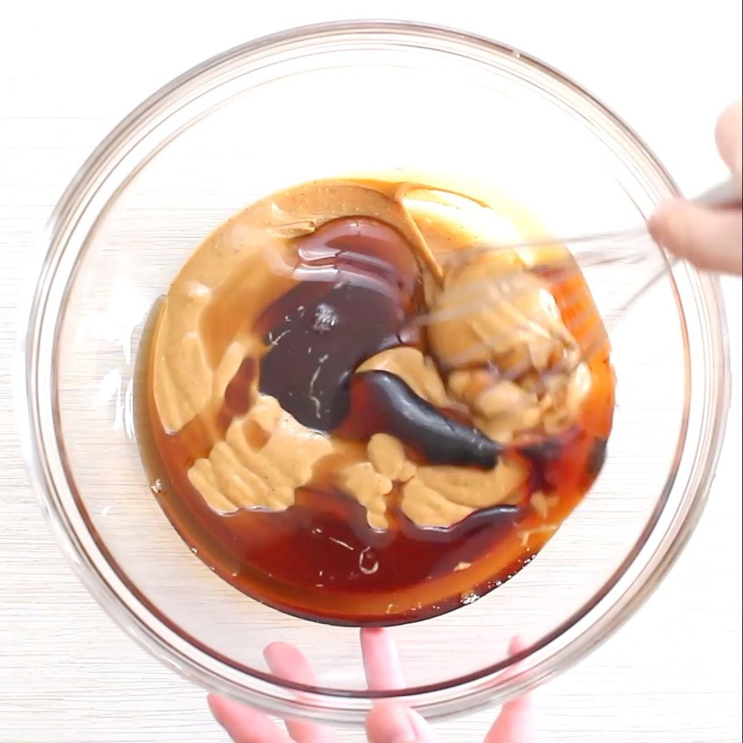 A photo showing how to make no bake chocolate oatmeal cookies - stirring together peanut butter and maple syrup