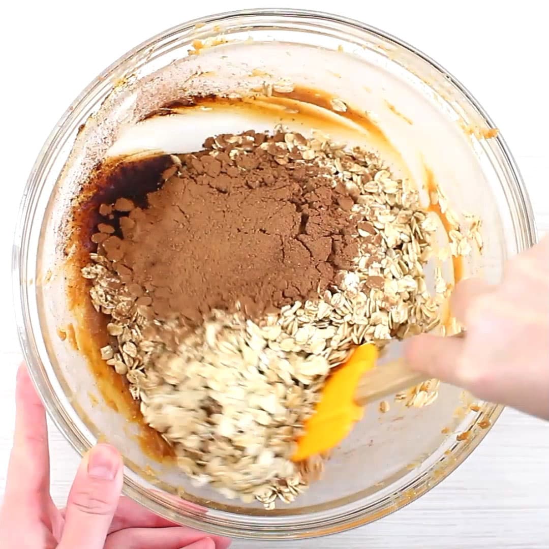 hand stirring and folding healthy no bake cookies mixture in a mixing bowl