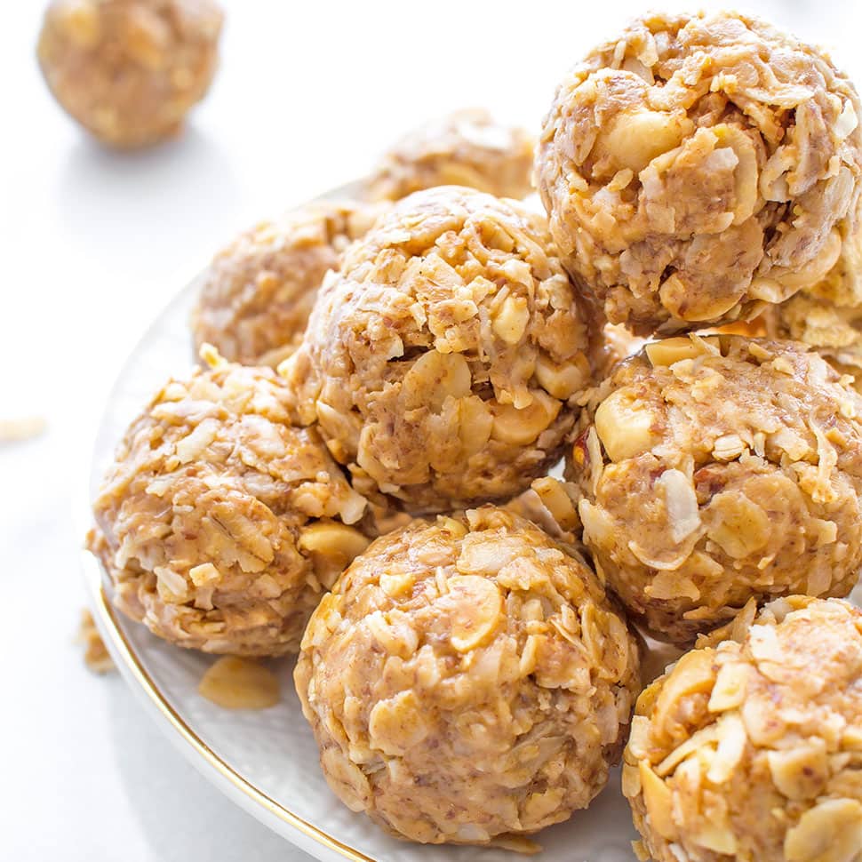 Gold rimmed plate with stack of peanut butter coconut bites on top