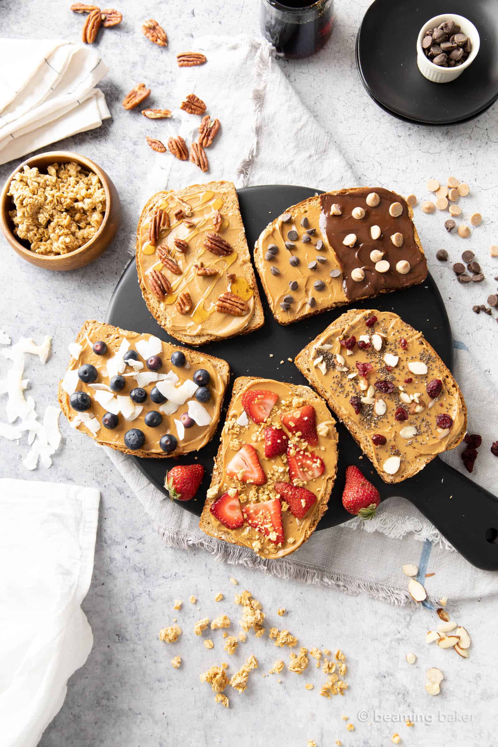Five kinds of peanut butter toast recipe laid out on a black serving board