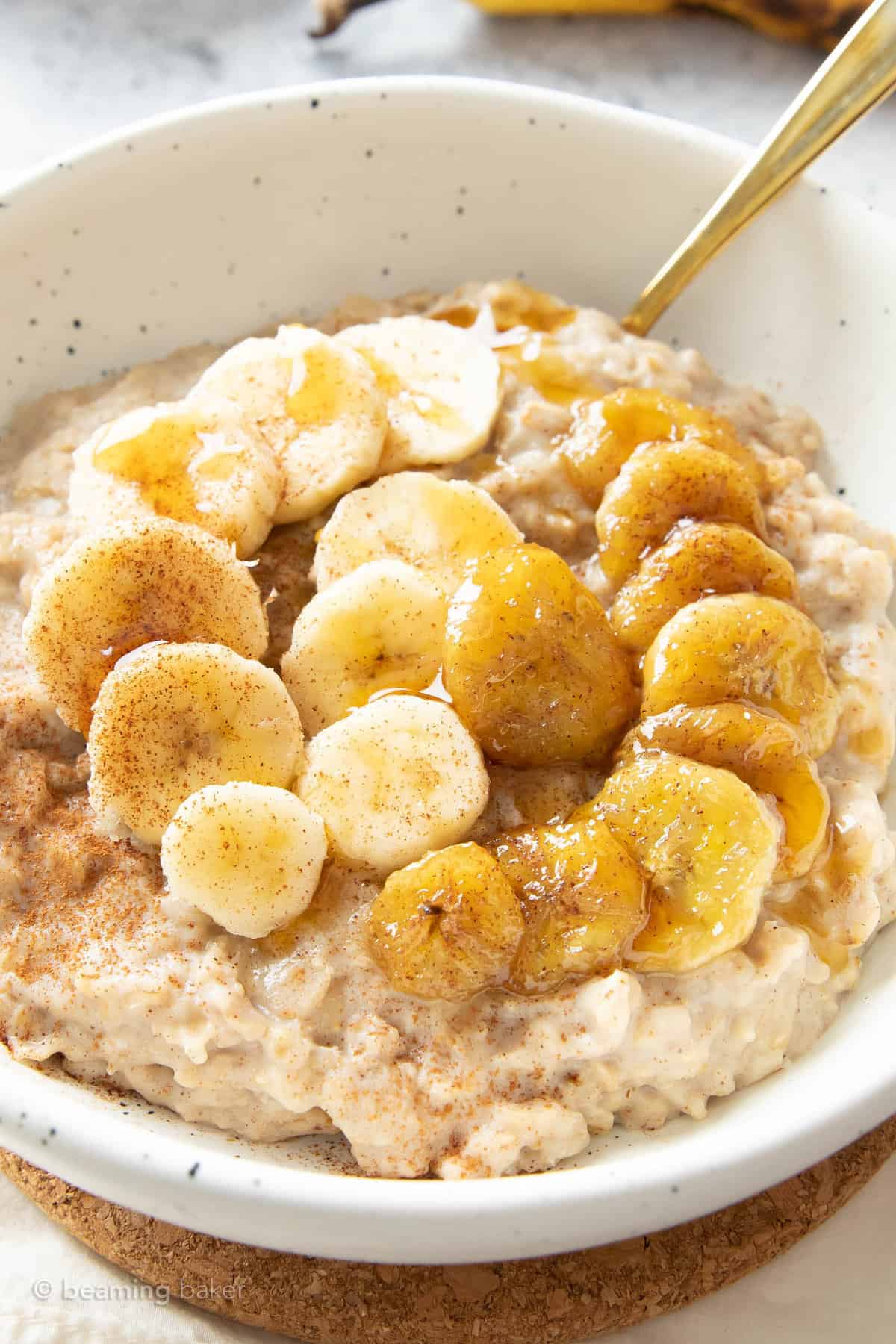 Closeup of maple syrup and fruit on a bowl of protein oatmeal