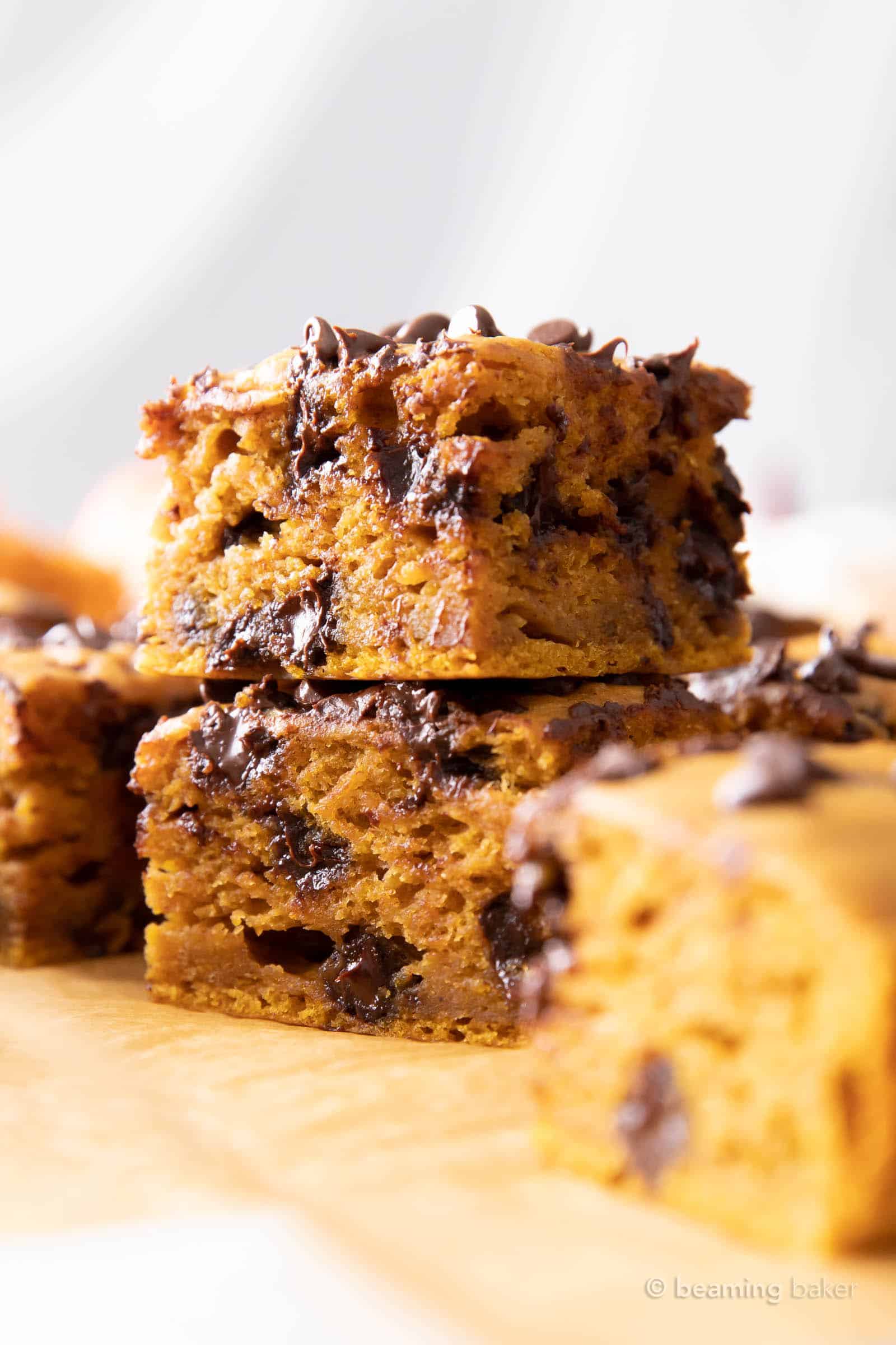 Closeup of two pumpkin chocolate chip bars stacked one on top of another