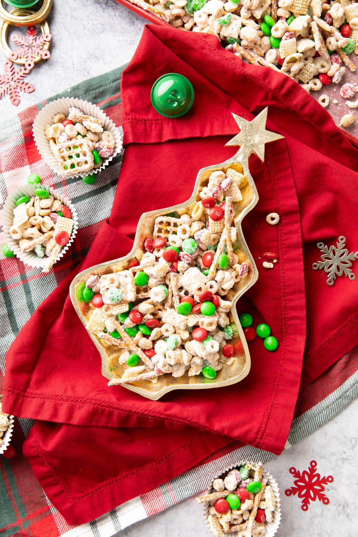 Gold Christmas tree-shaped serving dish filled with Christmas Puppy Chow