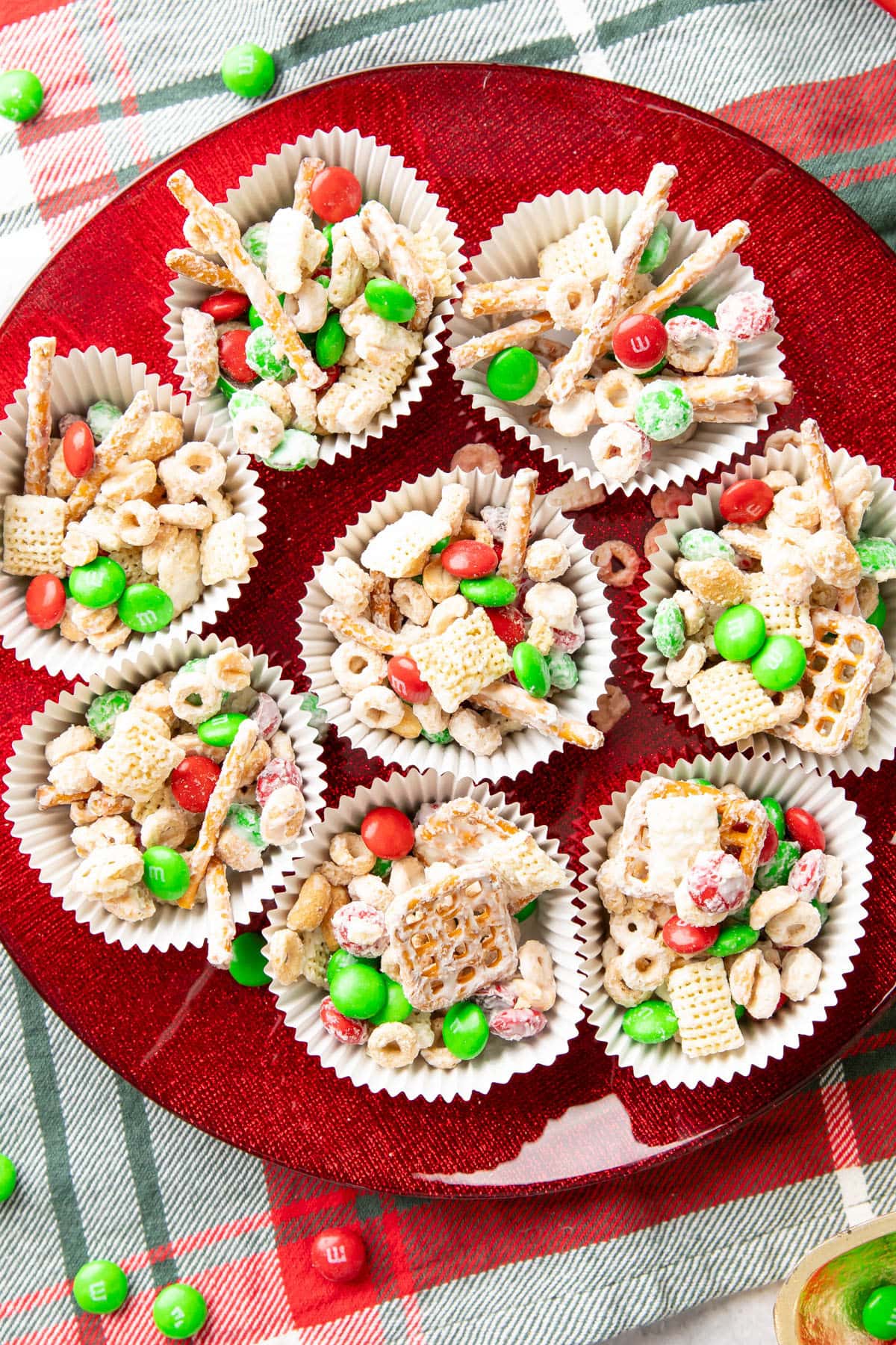Christmas puppy chow in individual cups on a red serving tray