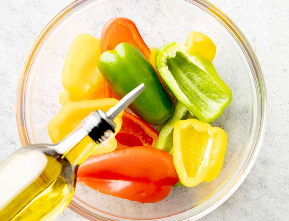 Photo showing How to make Roasted Bell Peppers – pouring in olive oil