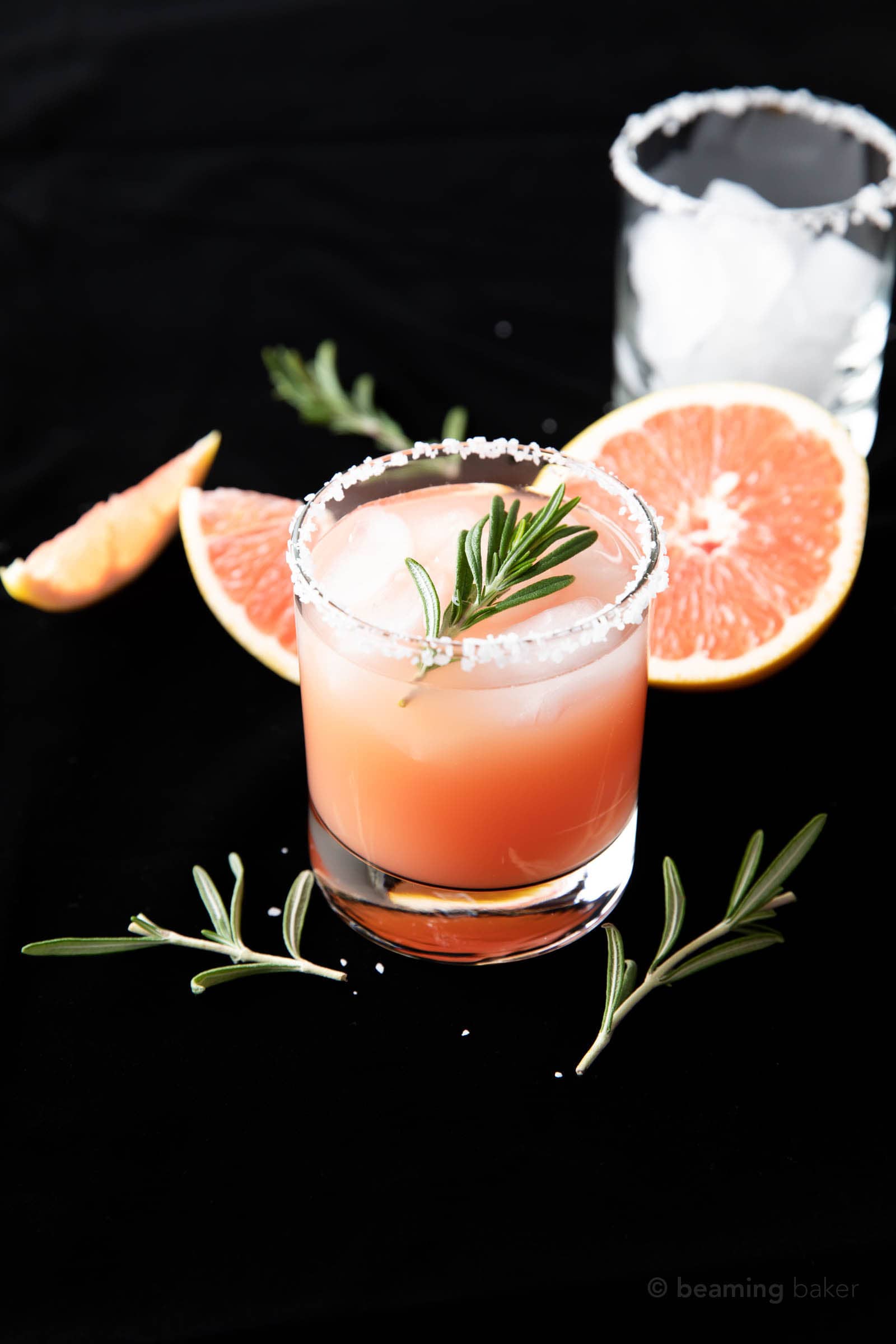 salt rimmed Salty Dog Cocktail Recipe in a rocks glass garnished with rosemary on a black velvet backdrop