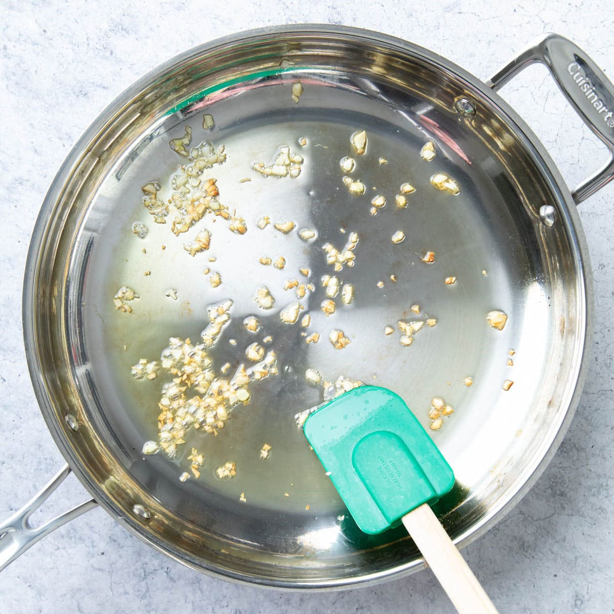Cooking up minced garlic for the tomato basil pasta in a stainless steel skillet