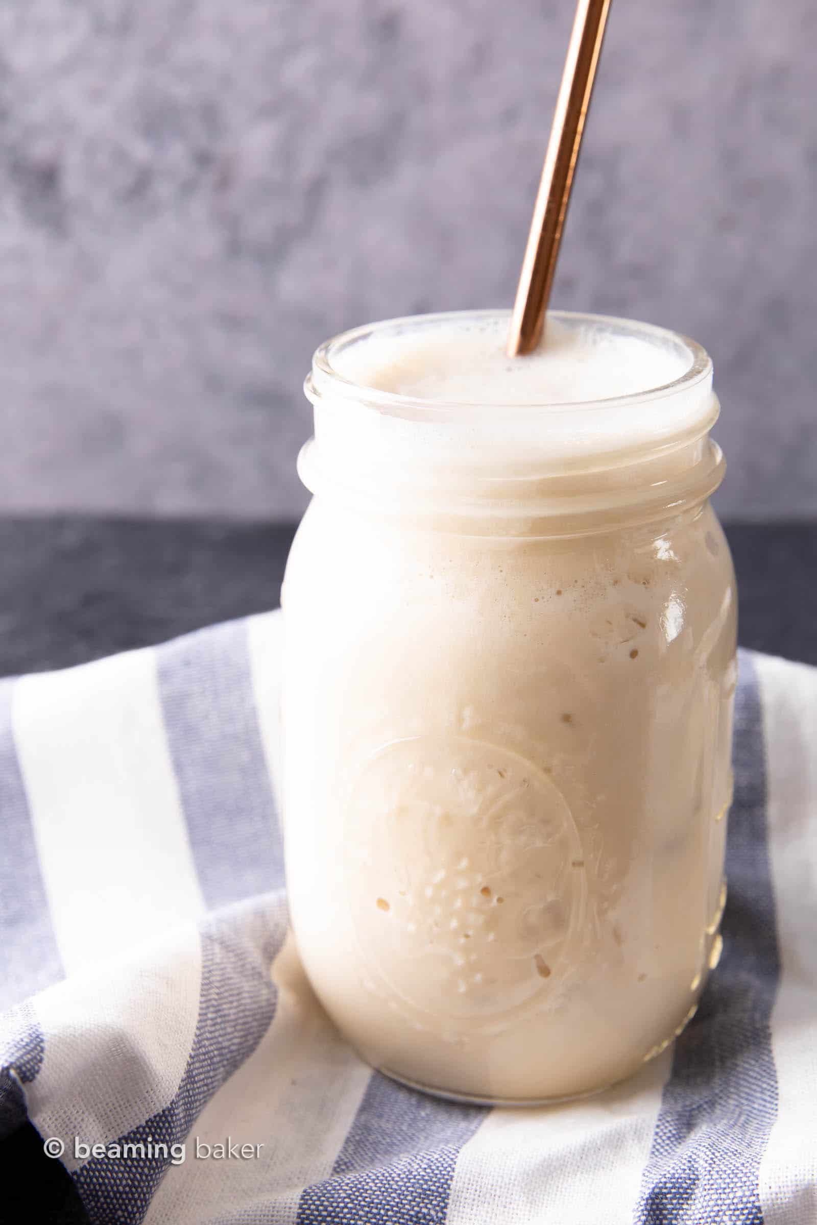 Vegan protein shake in mason jar on blue and white striped cloth