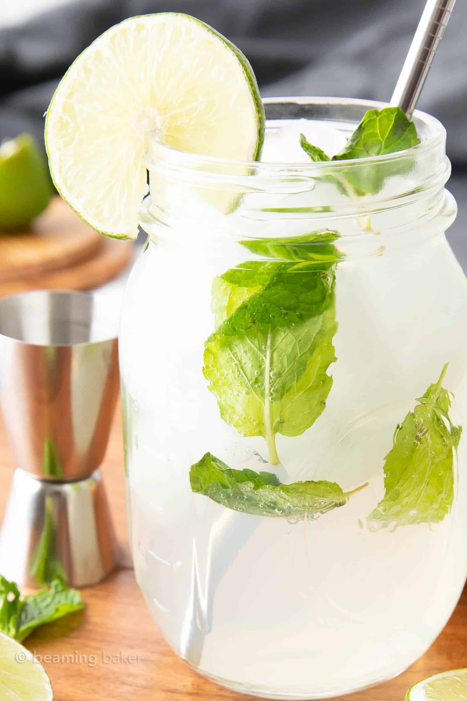 super closeup shot of virgin mojito mocktail in glass with cocktail tools in the background